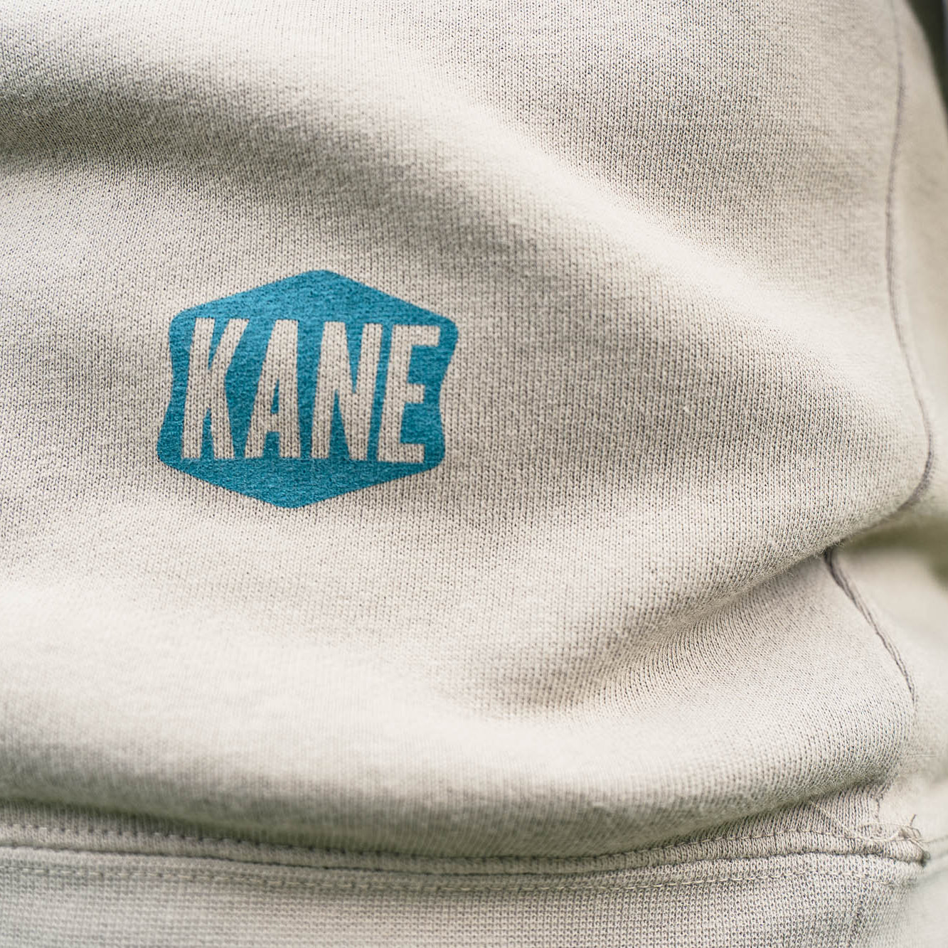 Kane Stamp Logo on the back of hoodie.