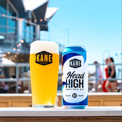 Kane Brewing Company Head High beer can and glass with Tim McLoone's Supper Club in the background on Asbury Park boardwalk.